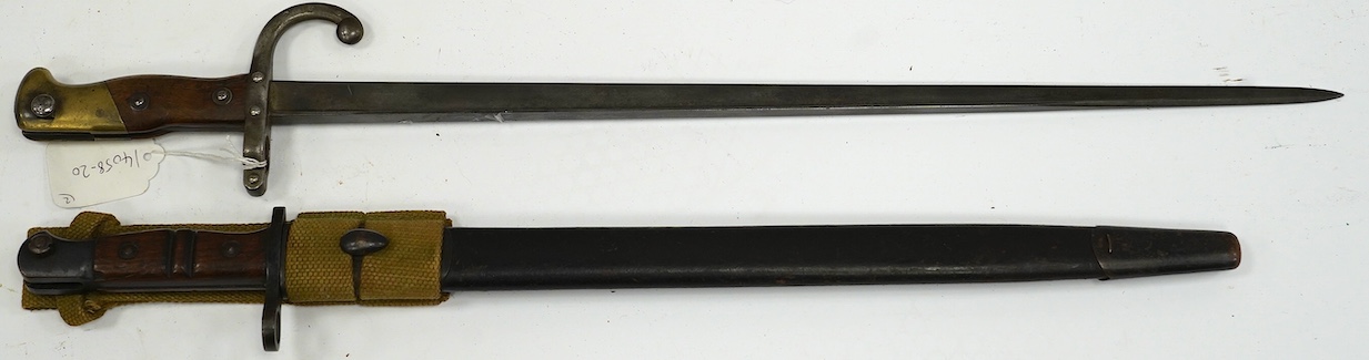 Two bayonets; a good Remington bayonet dated 1913 in its leather scabbard with khaki frog dated 1940, and a Gras bayonet dated 1880. Condition - good